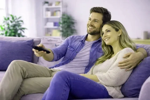 A family watching TivioneTV on the living-room television